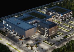Blick von oben auf einen Firmensitz mit Bürogebäude, Parkhaus und Parkplätzen, Lager mit Lkw-Ladestationen